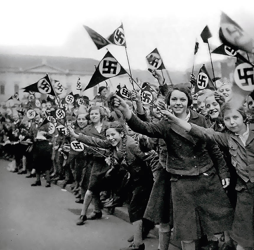 Members of the League of German Girls wave Nazi flags in support of the German annexation of Austria in Vienna, Austria, March 1938  (Photo courtesy of the United States Holocaust Memorial Museum)